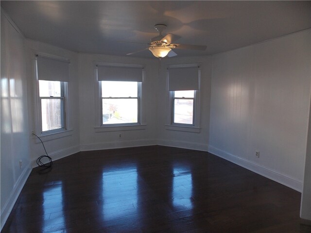 empty room featuring ceiling fan and dark wood-type flooring