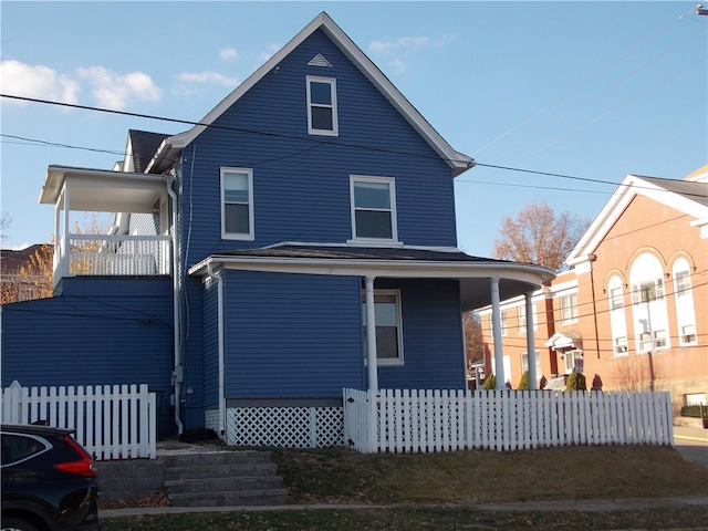 rear view of house featuring a porch