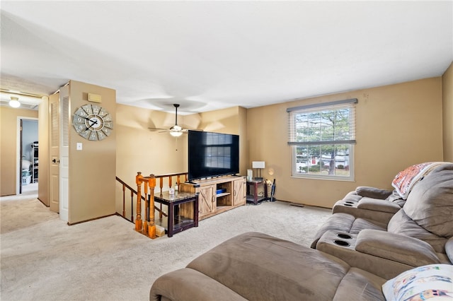 living room with light carpet and ceiling fan