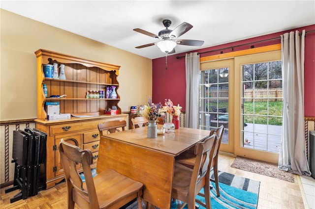 dining area with ceiling fan and light parquet flooring