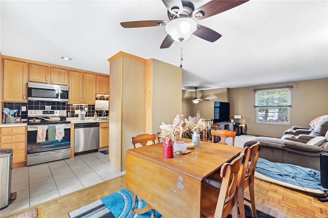 dining area featuring ceiling fan and light tile patterned floors