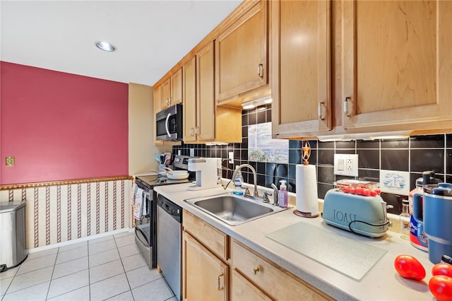 kitchen with stainless steel appliances, sink, and light tile patterned floors