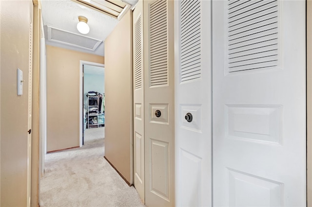 hallway featuring light carpet