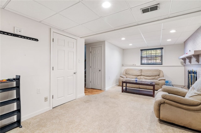 carpeted living room with a brick fireplace