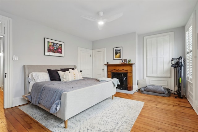 bedroom with ceiling fan and wood-type flooring