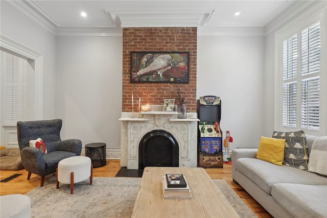 living room with crown molding and hardwood / wood-style floors