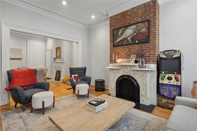 living room featuring a fireplace, light wood-type flooring, and ornamental molding