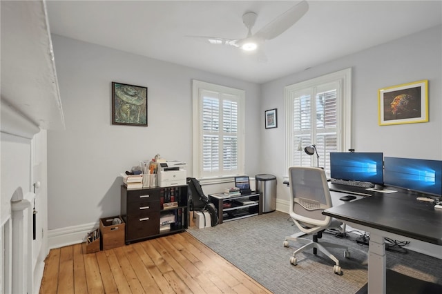 office with ceiling fan and light hardwood / wood-style floors