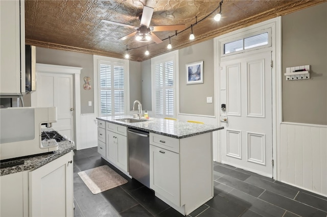 kitchen with stone counters, sink, white cabinetry, stainless steel dishwasher, and a kitchen island with sink