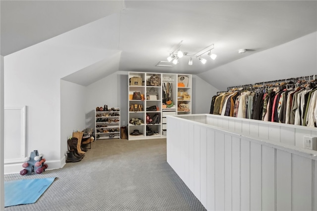 spacious closet with carpet floors and vaulted ceiling