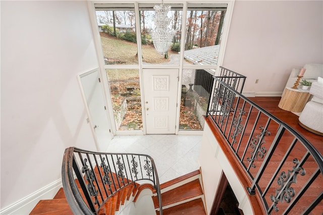 stairs with an inviting chandelier