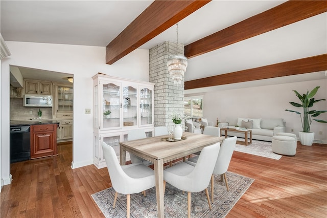 dining room with beam ceiling, light hardwood / wood-style flooring, and an inviting chandelier