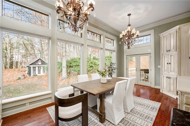 sunroom / solarium featuring french doors and a notable chandelier