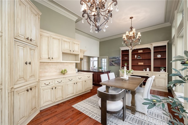 dining space featuring hardwood / wood-style floors, a notable chandelier, and ornamental molding