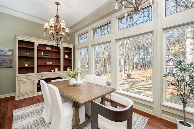 dining space with a chandelier, hardwood / wood-style flooring, plenty of natural light, and crown molding