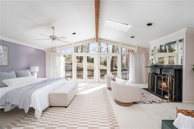 bedroom featuring access to exterior, vaulted ceiling with skylight, light colored carpet, ceiling fan, and crown molding