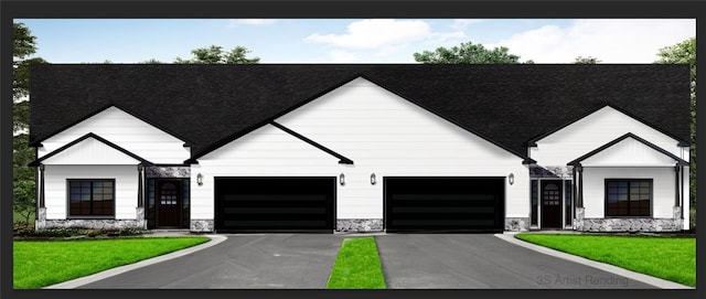 view of front of home featuring a front yard and a garage