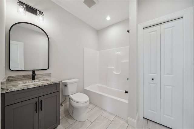 full bathroom featuring washtub / shower combination, vanity, and toilet