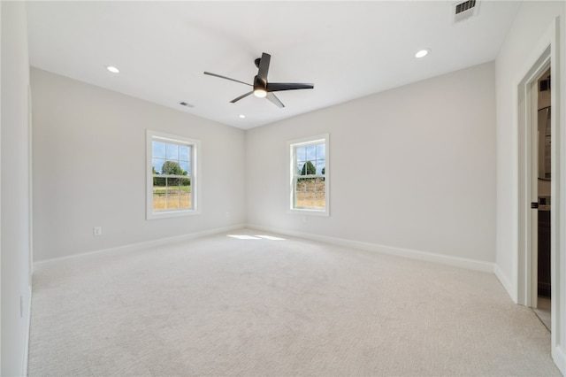 empty room featuring light colored carpet and ceiling fan