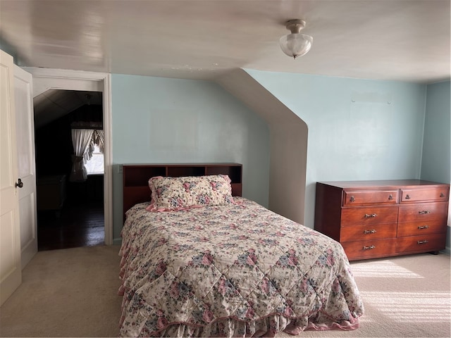 bedroom with light carpet and lofted ceiling