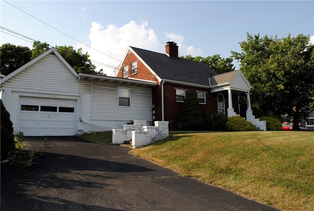 view of front of home with a garage and a front yard