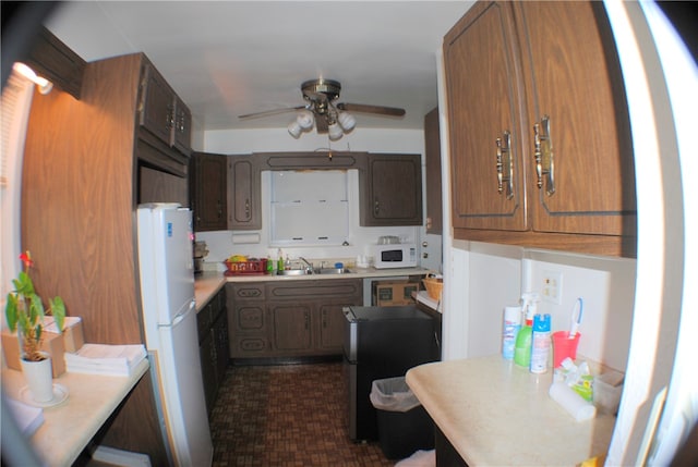 kitchen featuring white appliances, sink, and ceiling fan