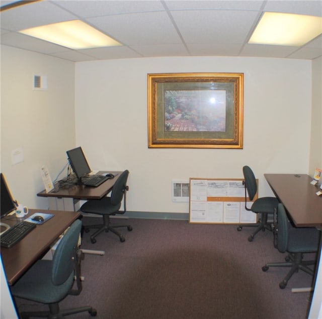 carpeted home office with a drop ceiling