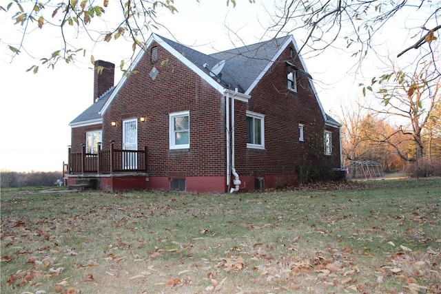 view of side of property with a lawn