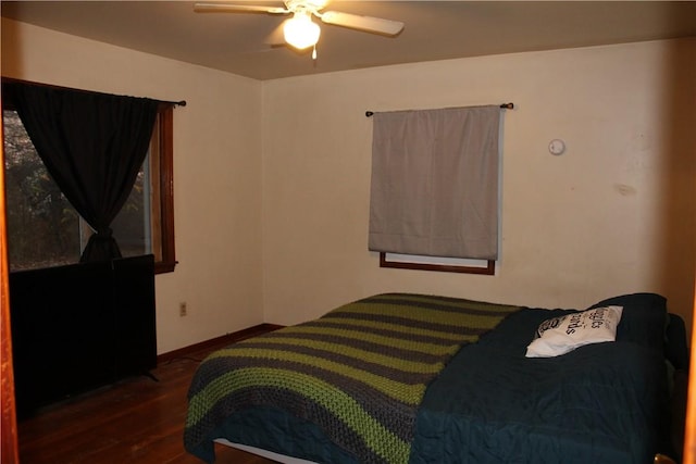 bedroom with ceiling fan and dark hardwood / wood-style flooring