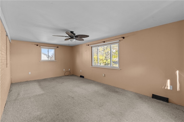 carpeted empty room featuring ceiling fan