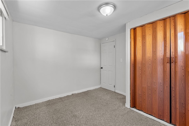 unfurnished bedroom with carpet flooring and a closet