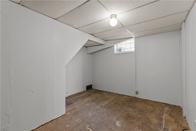 basement with a paneled ceiling