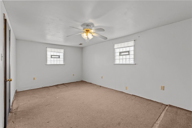 spare room with light carpet and ceiling fan