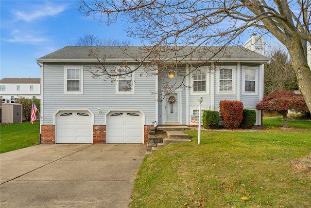 bi-level home featuring a front yard and a garage