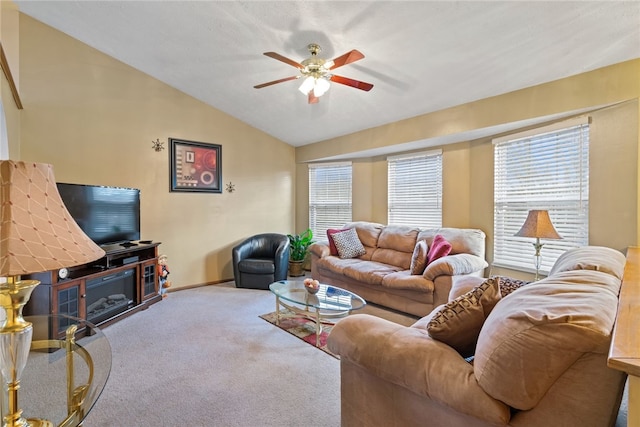 living room with carpet, vaulted ceiling, ceiling fan, and a healthy amount of sunlight