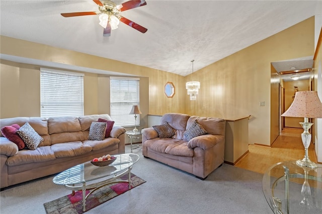 living room with ceiling fan, light carpet, and vaulted ceiling