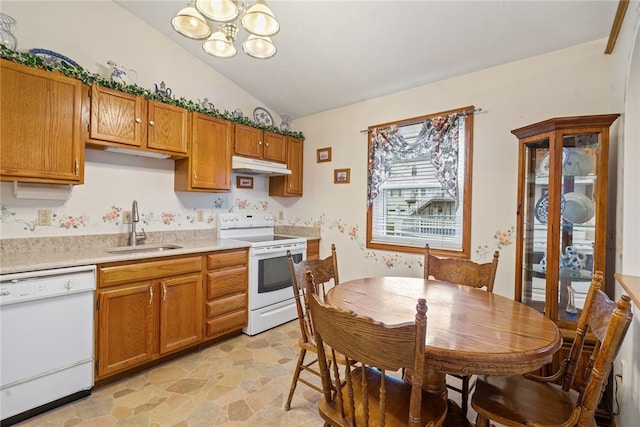 kitchen with vaulted ceiling, sink, a chandelier, and white appliances