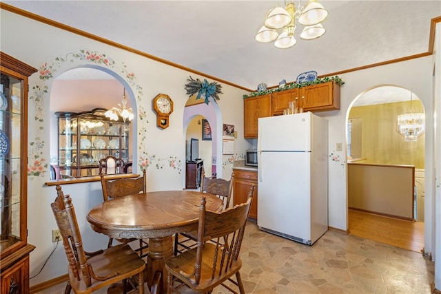 dining room with a chandelier and crown molding