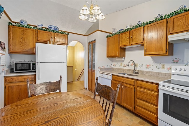 kitchen with white appliances, sink, a chandelier, hanging light fixtures, and lofted ceiling