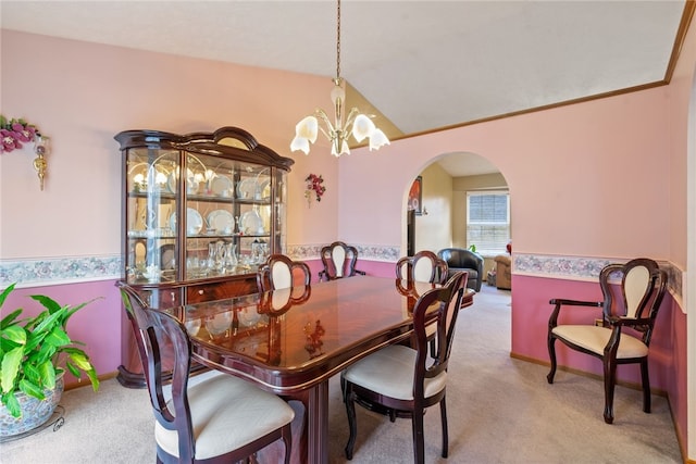 carpeted dining room with a notable chandelier