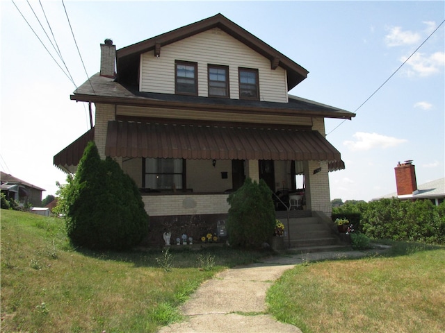 view of front of property with covered porch and a front yard