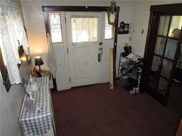 entryway with dark colored carpet