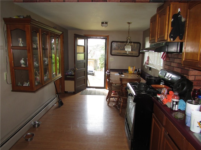 kitchen with stainless steel range with gas cooktop, light hardwood / wood-style floors, decorative light fixtures, and a baseboard heating unit