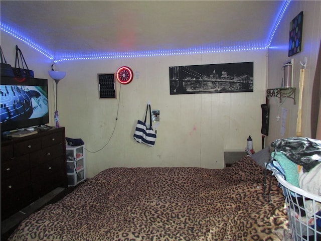 bedroom featuring wood walls