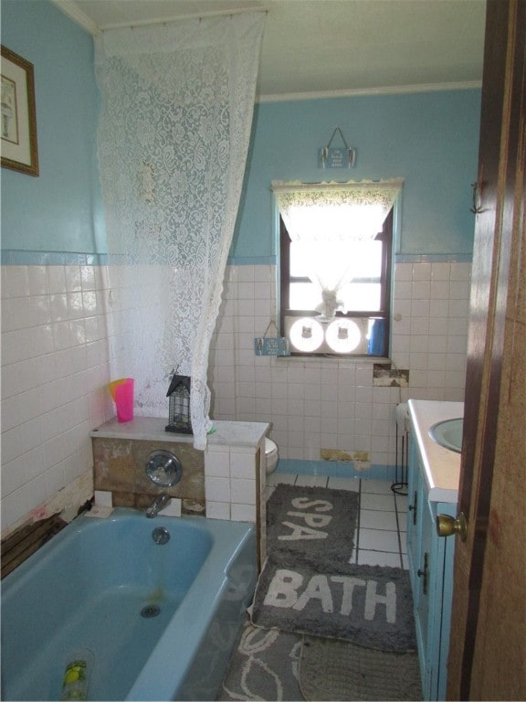 bathroom with tile walls, vanity, ornamental molding, and tile patterned floors