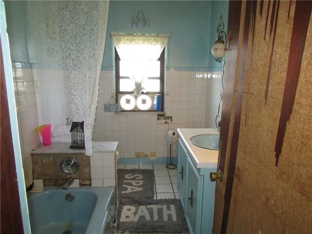 bathroom featuring vanity, a washtub, tile walls, and tile patterned floors