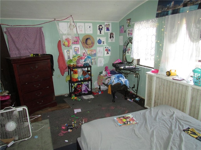 bedroom featuring radiator and vaulted ceiling