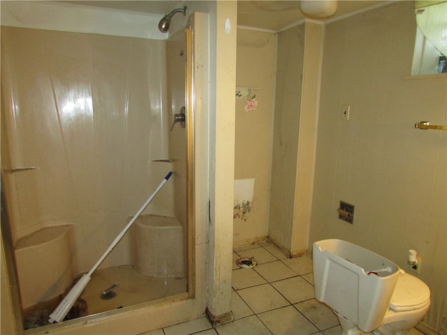 bathroom featuring toilet, tile patterned flooring, and walk in shower