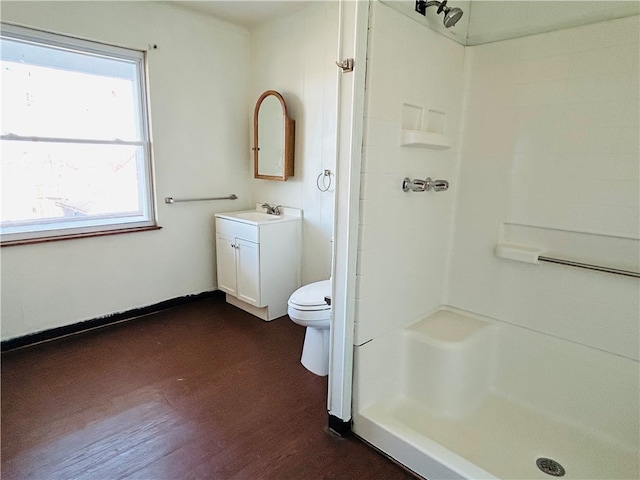 bathroom with toilet, a shower, wood-type flooring, and vanity