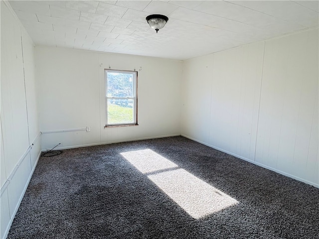 unfurnished room with dark carpet